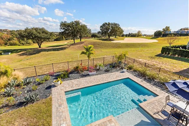 an aerial view of residential houses with outdoor space and ocean view