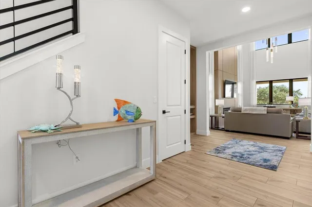 a living room with furniture a flat screen tv and a table