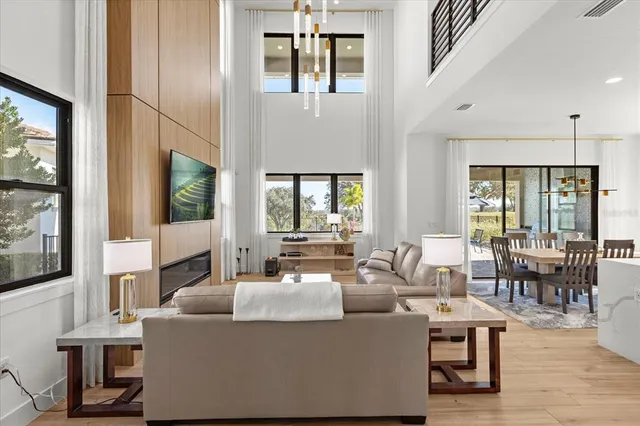 a living room with furniture a large window and a flat screen tv