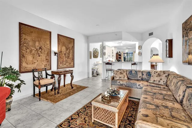 a living room with furniture a lamp and a large window