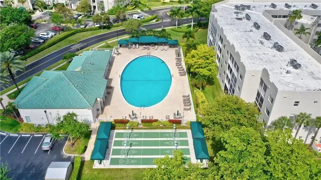 an aerial view of a city with lots of residential buildings and mountain view in back