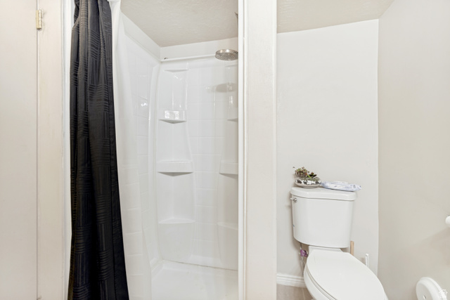 843 Deer Flat Road Tooele, UT 84074 - Photo 20 of 27 Full shower stall with integrated shelving and a chrome showerhead