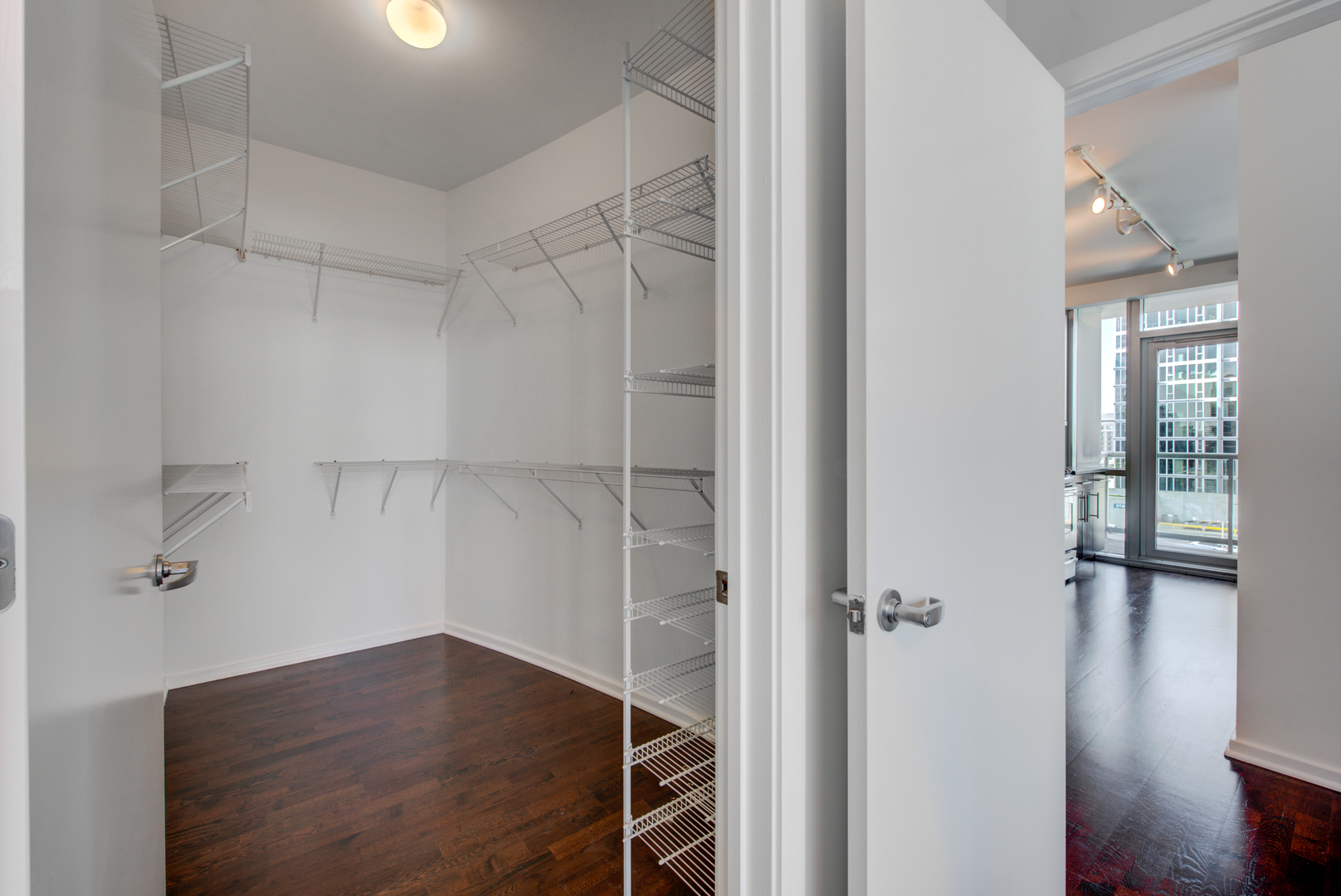 123 South Green Street, Unit 803B Chicago, IL 60607 - Photo 17 of 32 an empty room with wooden floor closet and windows