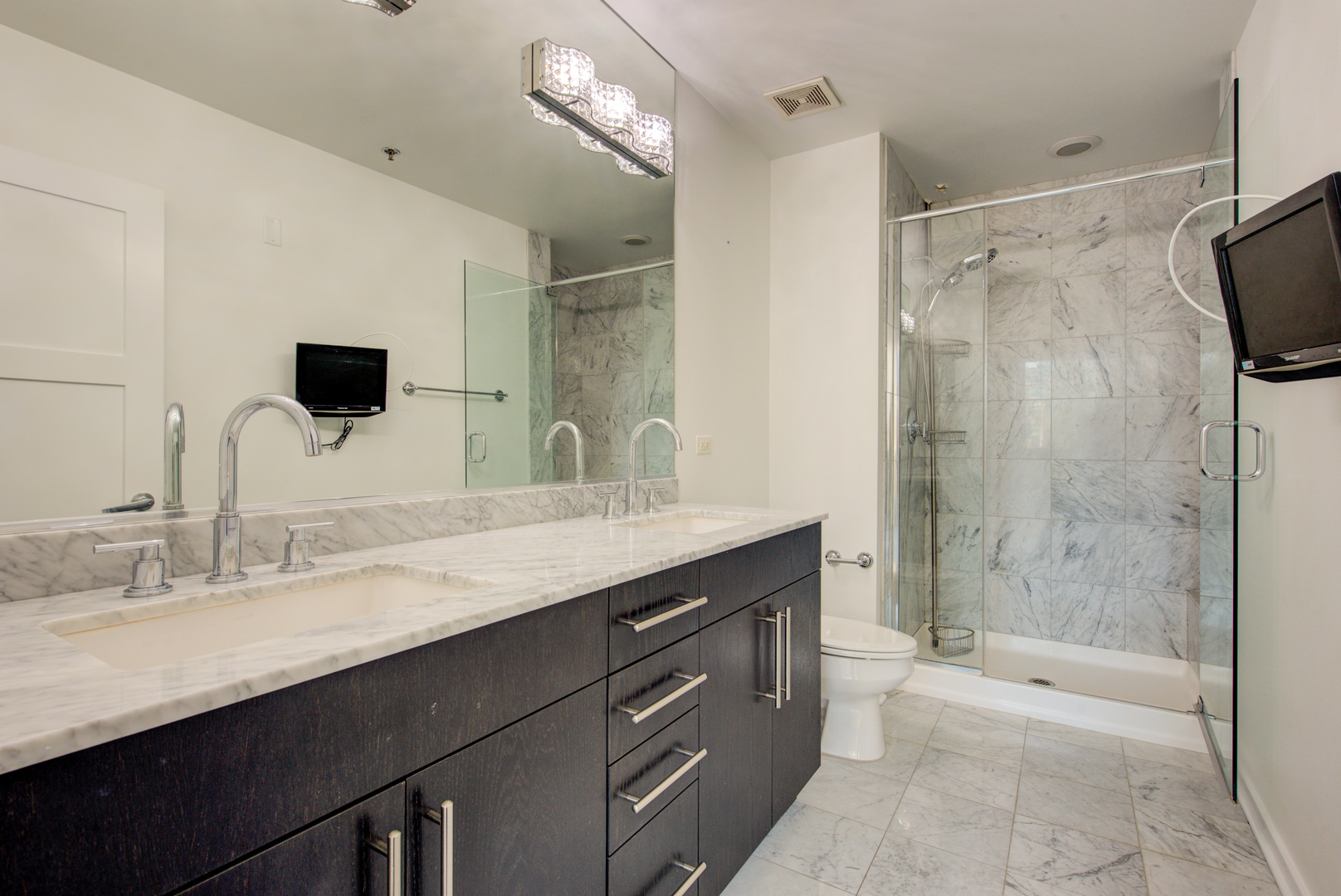 123 South Green Street, Unit 803B Chicago, IL 60607 - Photo 19 of 32 a bathroom with a granite countertop sink a mirror a bathtub and shower