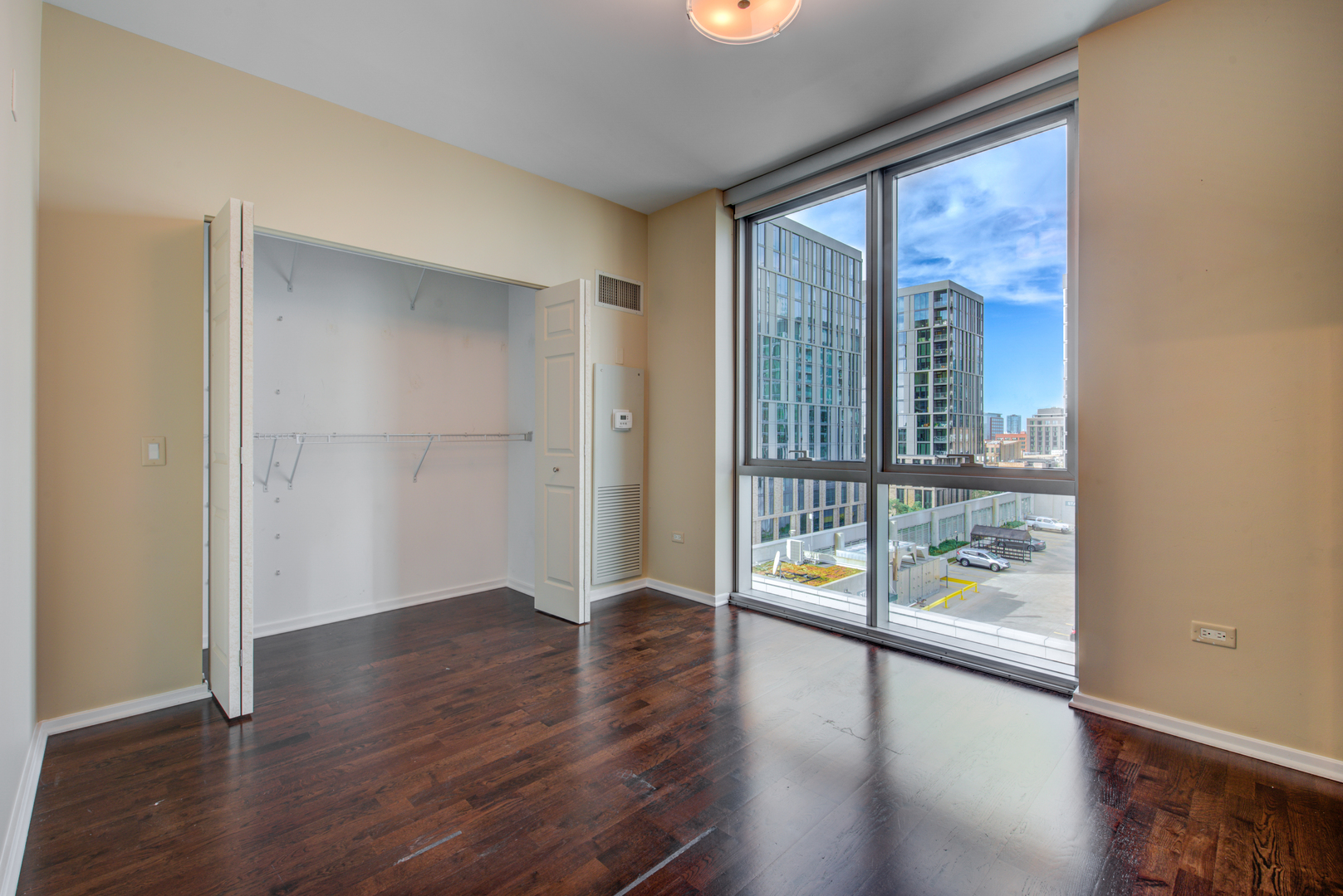 123 South Green Street, Unit 803B Chicago, IL 60607 - Photo 21 of 32 wooden floor in an empty room with a window