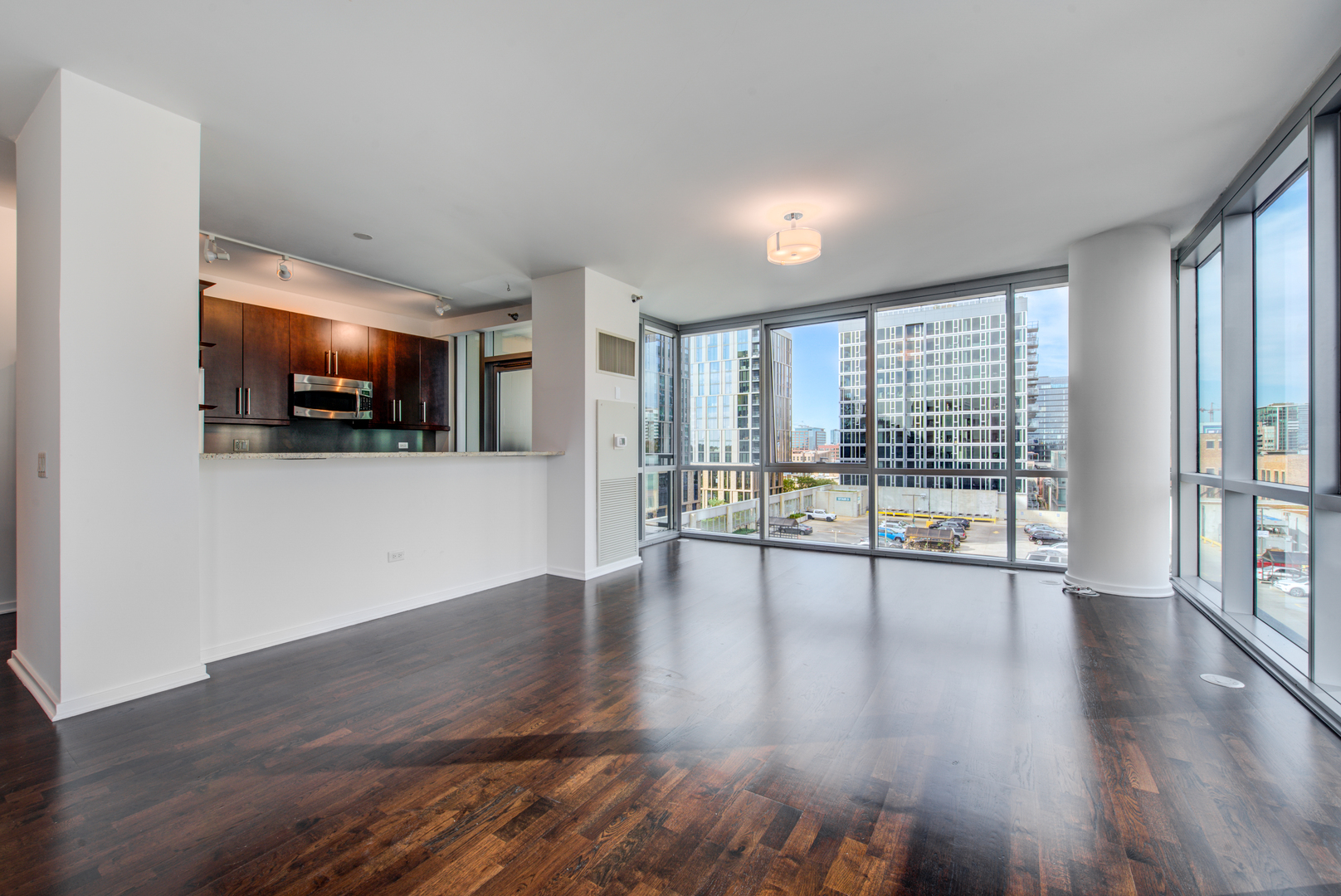 123 South Green Street, Unit 803B Chicago, IL 60607 - Photo 5 of 32 a view of an empty room with wooden floor and a window