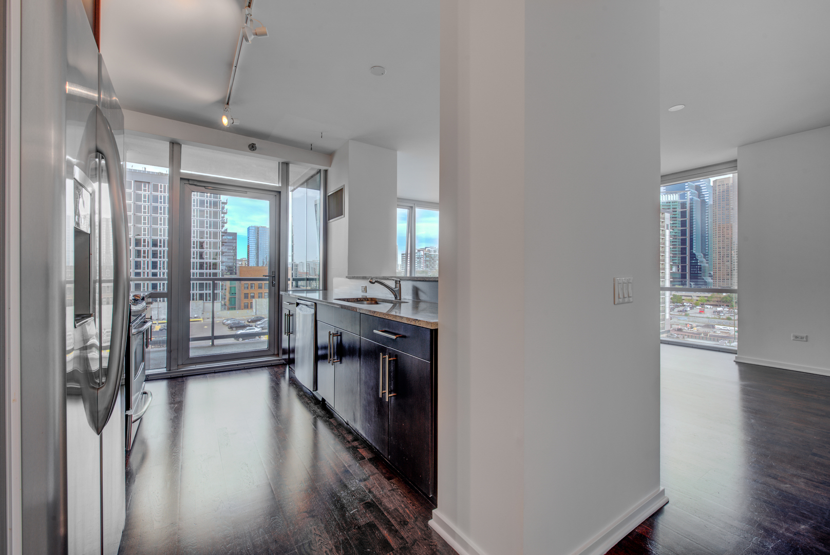 123 South Green Street, Unit 803B Chicago, IL 60607 - Photo 9 of 32 a view of a hallway with wooden floor and a living room