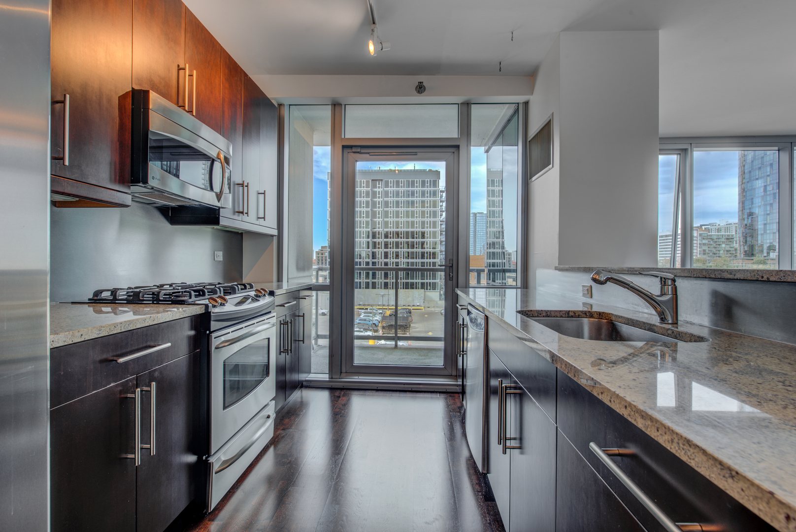 123 South Green Street, Unit 803B Chicago, IL 60607 - Photo 10 of 32 a kitchen with stainless steel appliances granite countertop a sink stove and cabinets