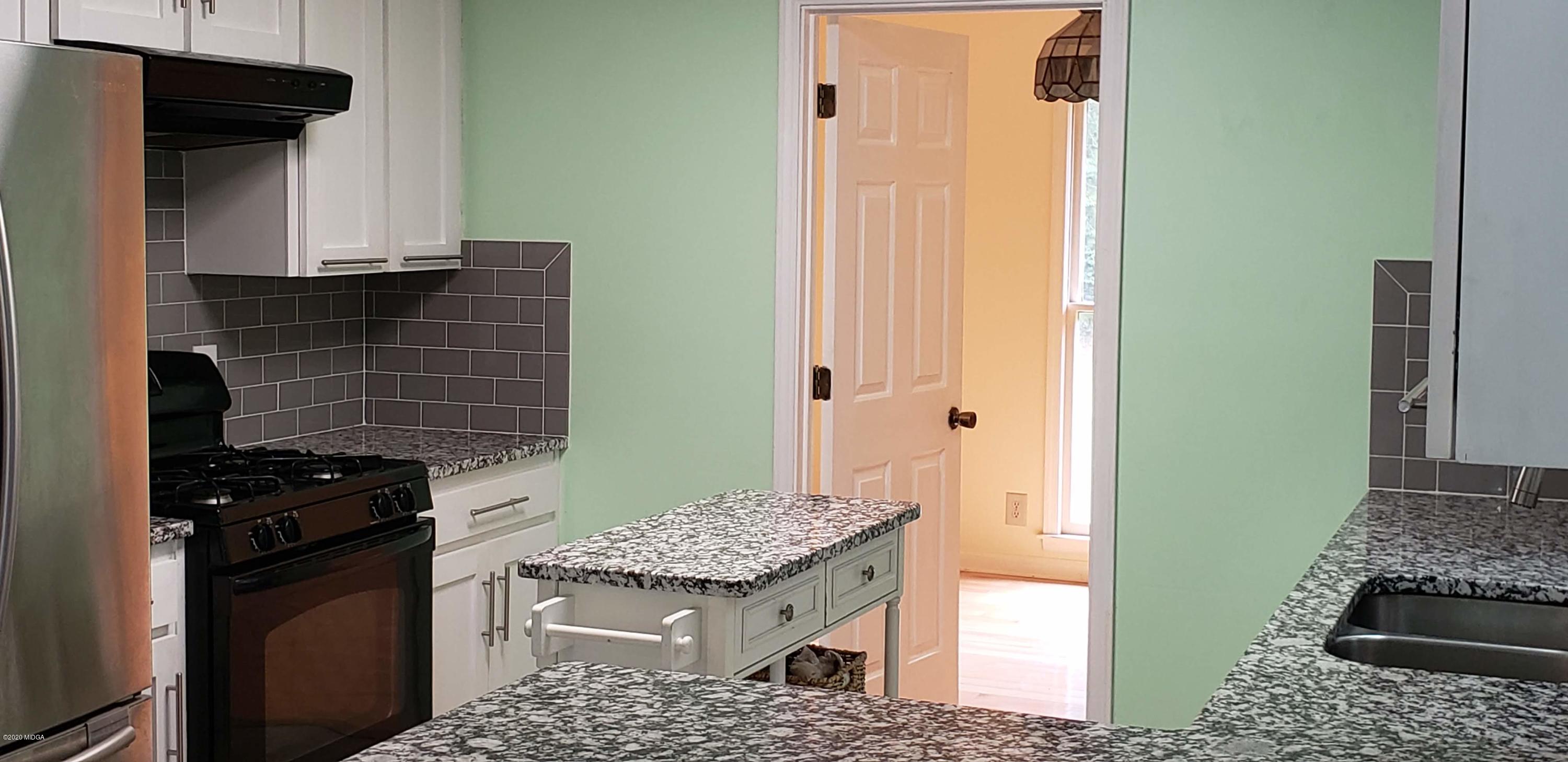291 Morton Road Gray, GA 31032 - Photo 9 of 33 a kitchen with a stove and a refrigerator