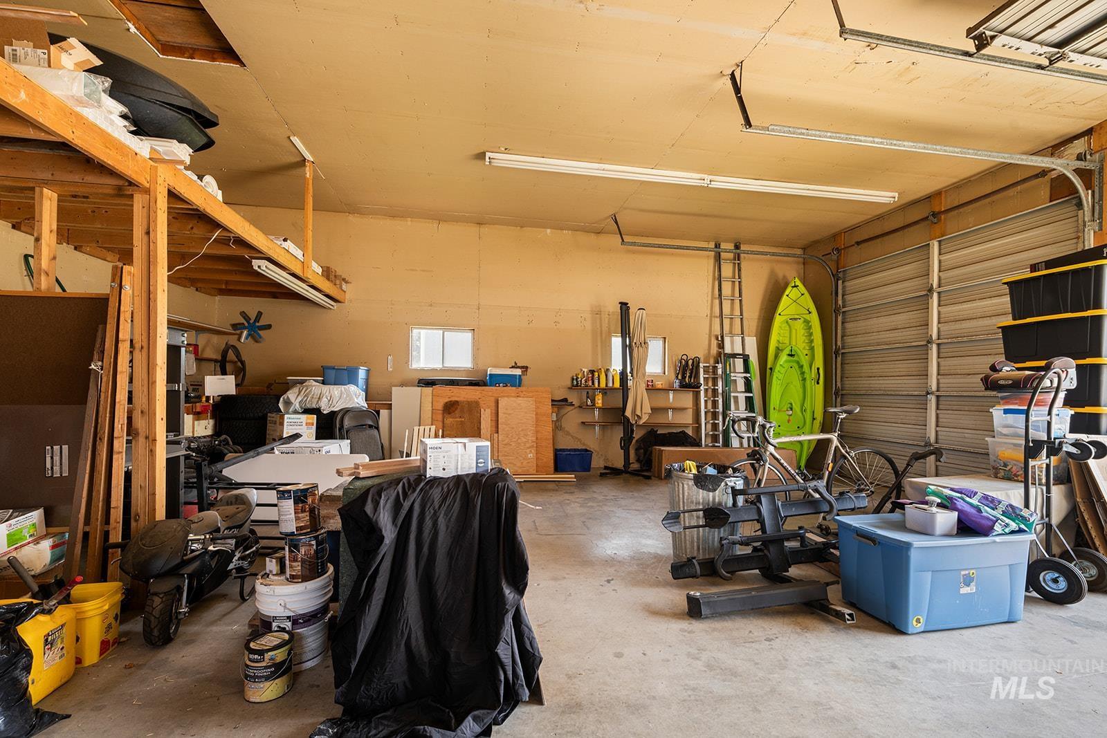 2007 Ripon Avenue Lewiston, ID 83501 - Photo 23 of 30 Spacious garage featuring a concrete floor, overhead fluorescent lighting, and an overhead garage door
