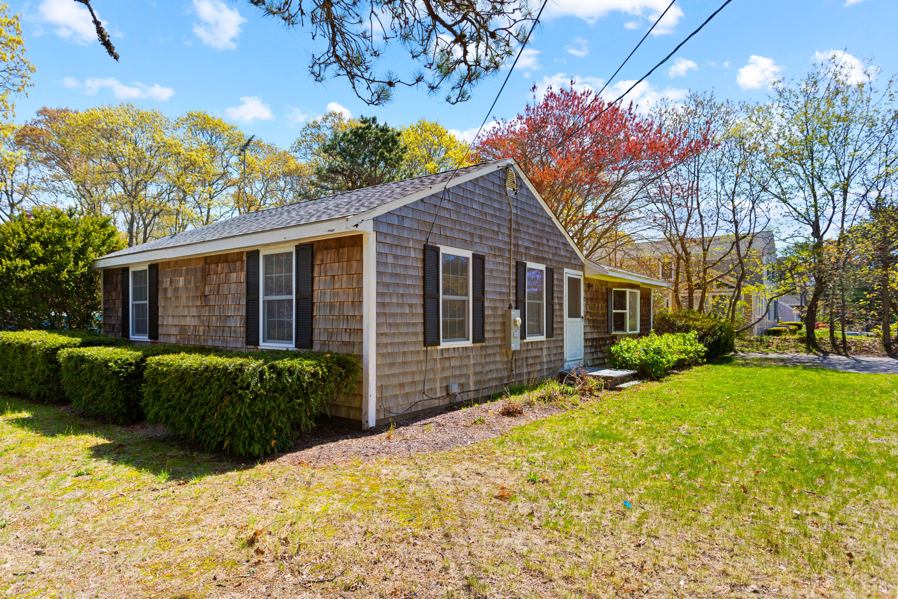 14 Greenwood Road Mashpee, MA 02649 - Photo 25 of 25 a front view of a house with a yard and outdoor seating