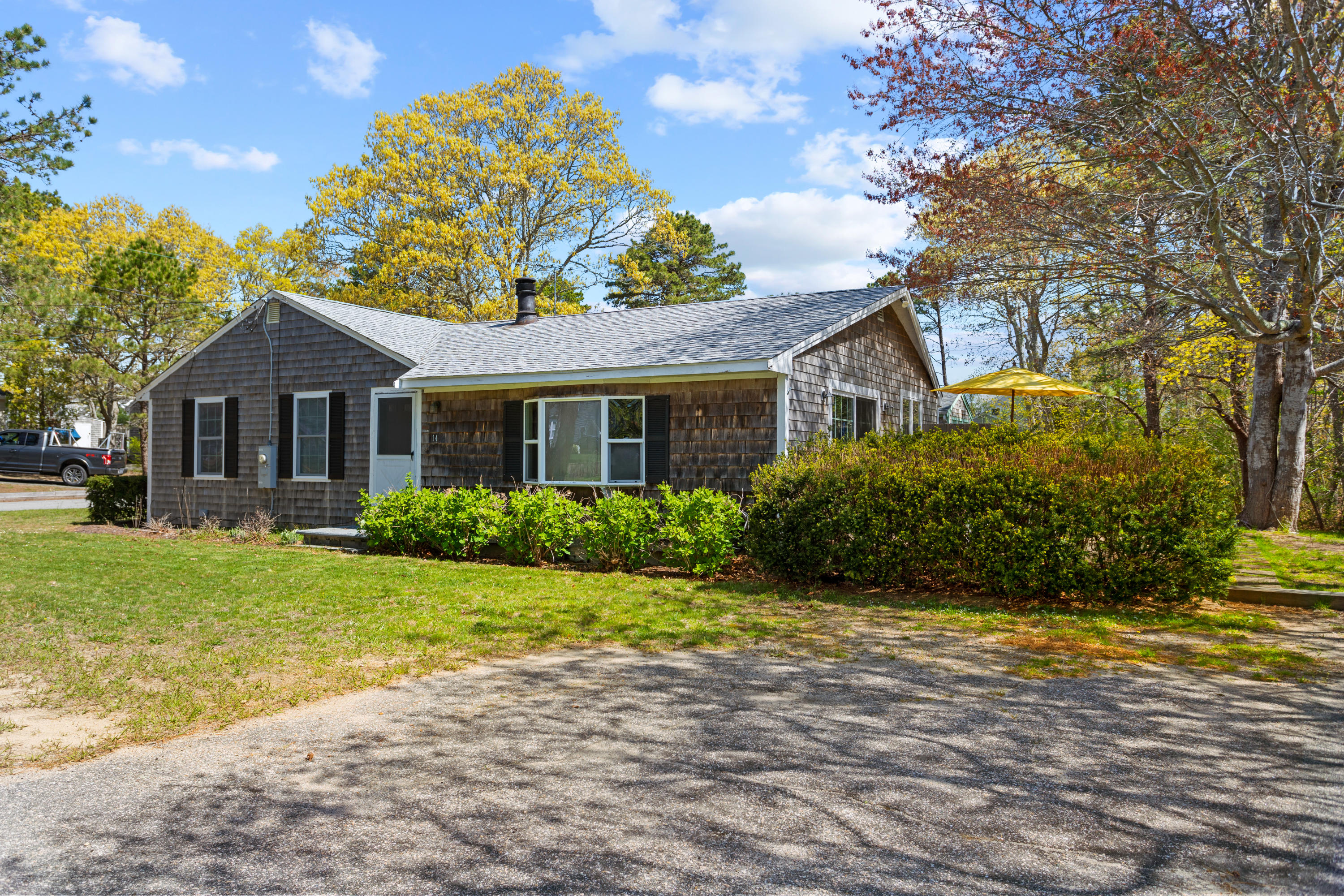 14 Greenwood Road Mashpee, MA 02649 - Photo 6 of 25 a front view of a house with a garden and yard
