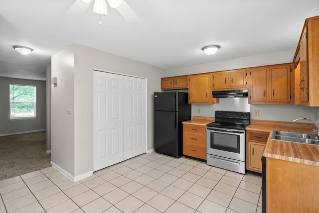 a kitchen with stainless steel appliances granite countertop a refrigerator stove and sink