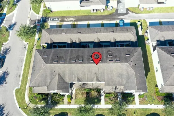 an aerial view of residential houses with outdoor space