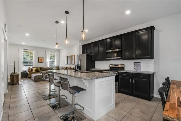 a large kitchen with lots of counter space dining table and chairs