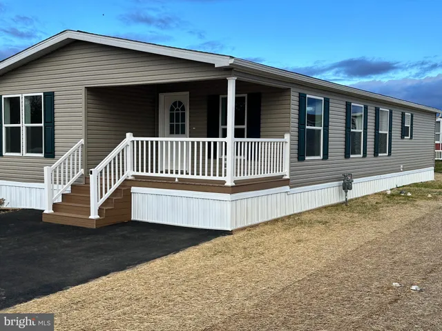 a view of a house with wooden fence