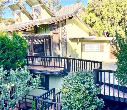 a view of a house with a deck and furniture