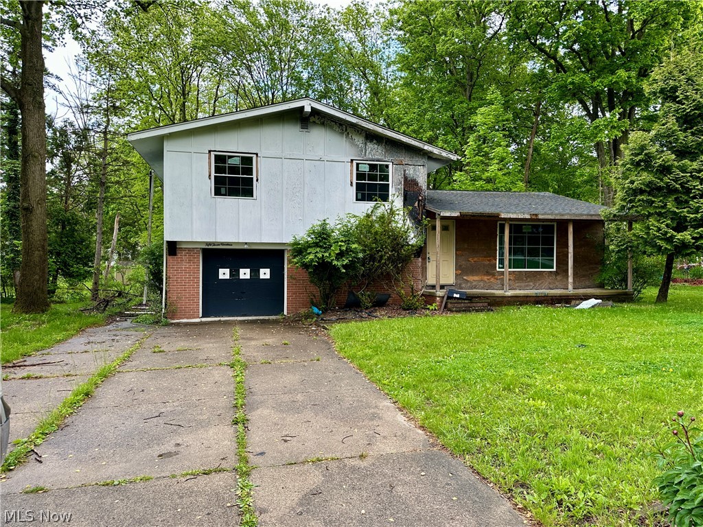 5319 Fairtree Road Bedford Heights, OH 44146 - Photo 2 of 27 Split-level home featuring a concrete driveway, brick accents, and a panel garage door