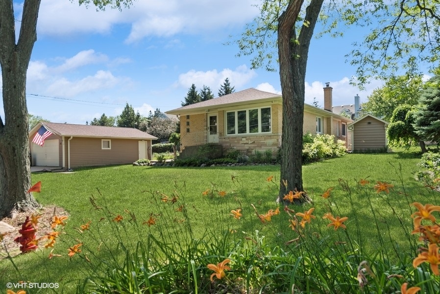 a view of house with backyard