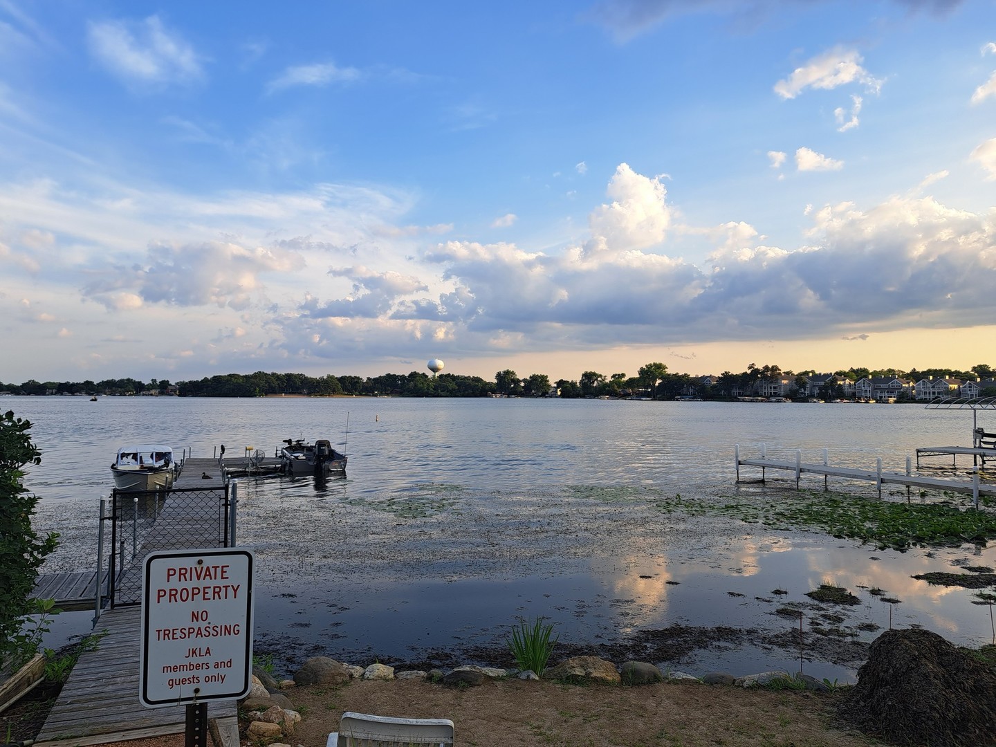 40 Pine Tree Row Lake Zurich, IL 60047 - Photo 3 of 22 a view of a lake with lawn chairs