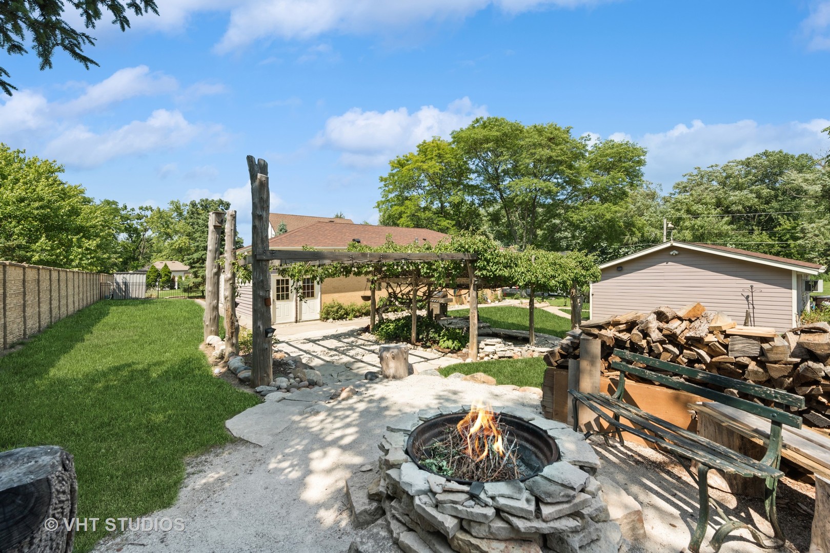 40 Pine Tree Row Lake Zurich, IL 60047 - Photo 6 of 22 a view of a patio with table and chairs with wooden fence
