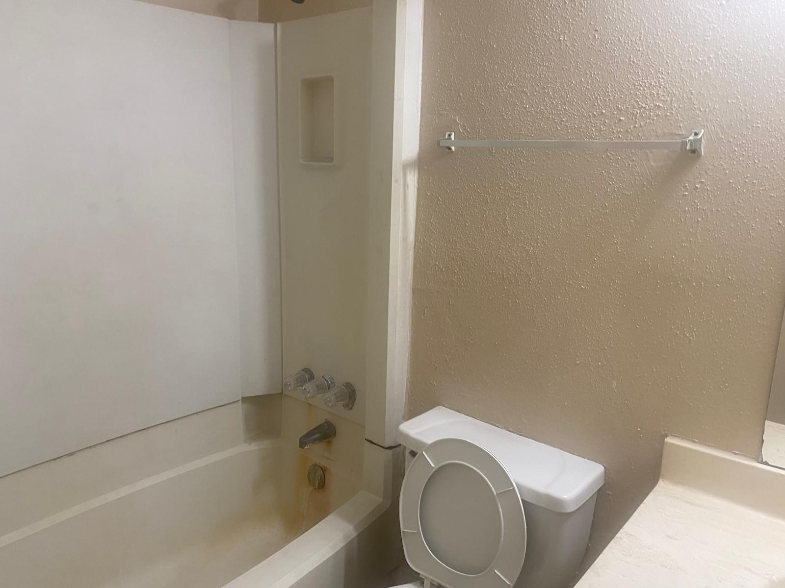 9546 Windswept Lane, Unit 9546 Houston, TX 77063 - Photo 8 of 12 a white toilet sitting next to a bath tub