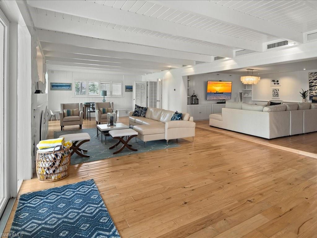 436 Golfview Drive Naples, FL 34110 - Photo 13 of 44 a living room with furniture and a flat screen tv