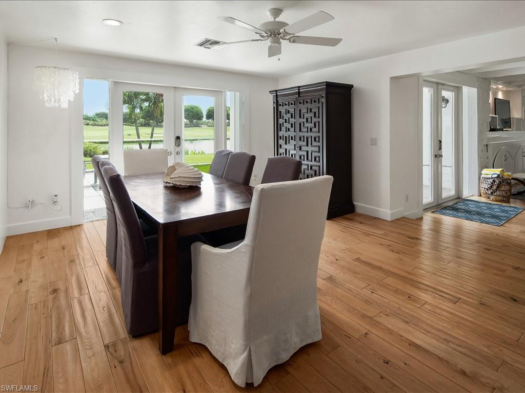 436 Golfview Drive Naples, FL 34110 - Photo 15 of 44 a view of a dining room with furniture window and wooden floor