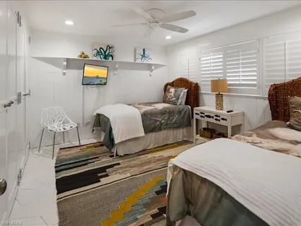 a bedroom with bed and a window