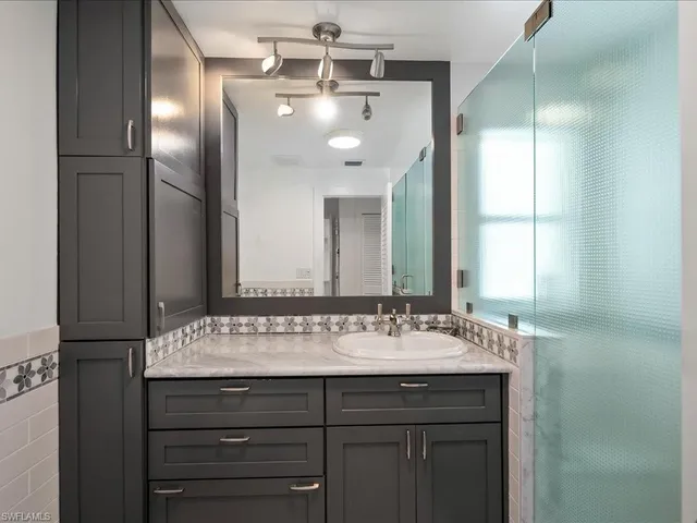 a bathroom with a sink and a mirror