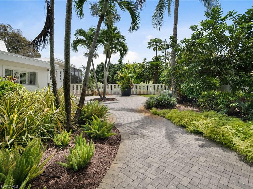436 Golfview Drive Naples, FL 34110 - Photo 35 of 44 a view of a backyard with potted plants and large trees