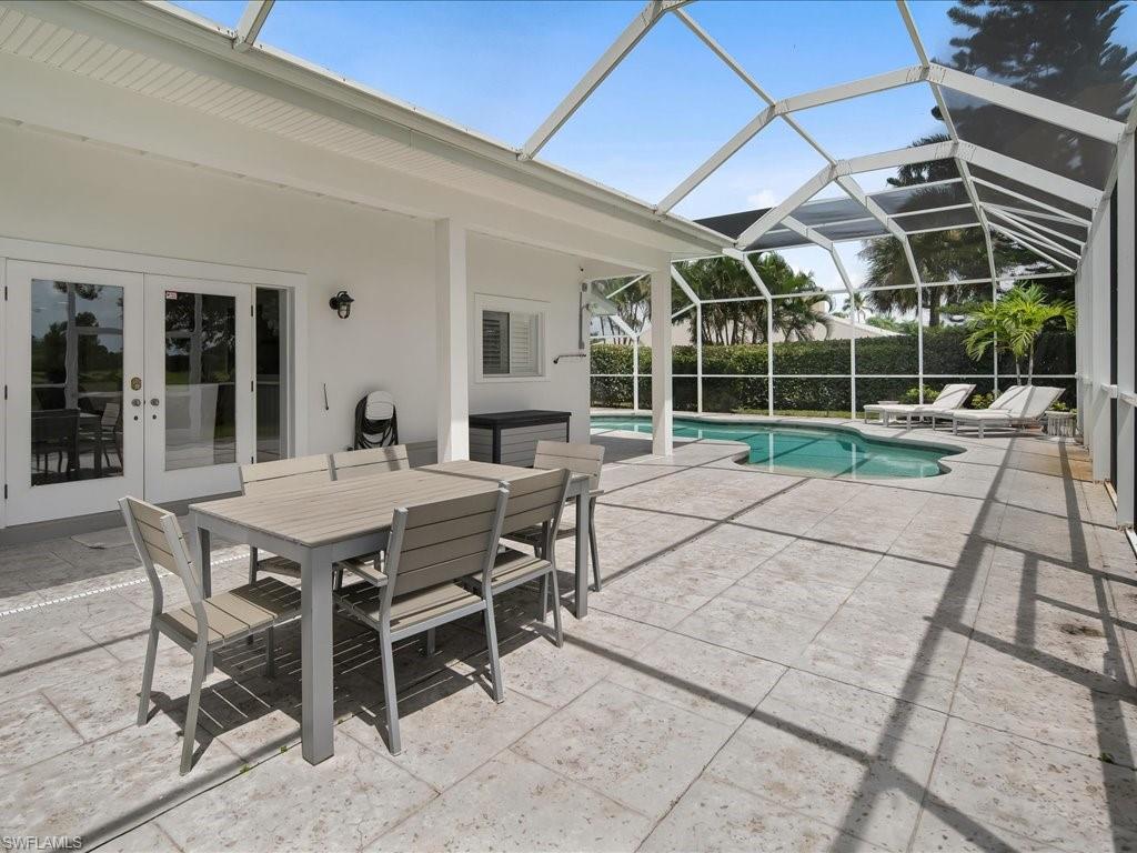 436 Golfview Drive Naples, FL 34110 - Photo 41 of 44 a patio with a table and chairs and potted plants