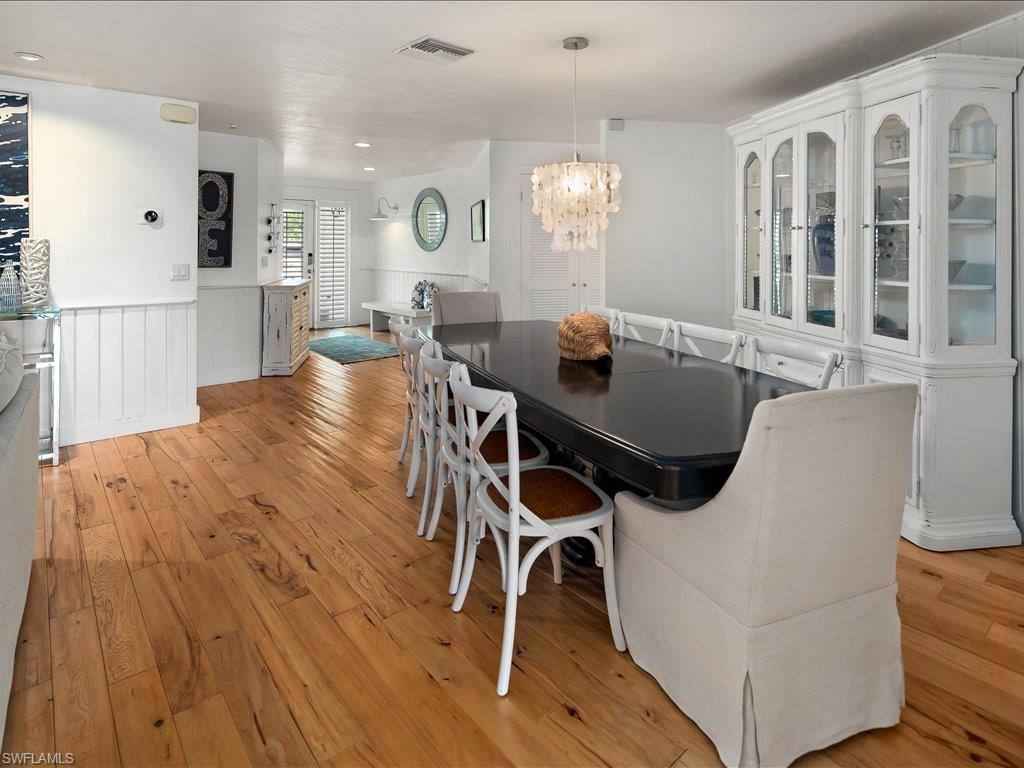 436 Golfview Drive Naples, FL 34110 - Photo 8 of 44 a view of a dining room with furniture and wooden floor