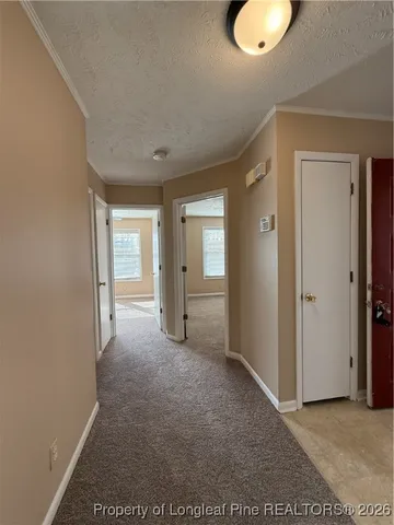 an empty room with closet area and bathroom