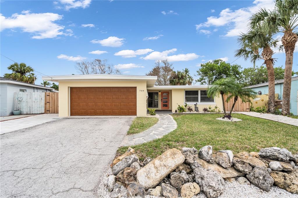 a view of a house with a yard and garage