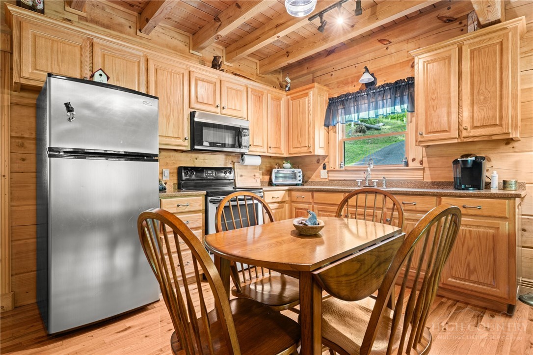 613 Silas Creek Road Lansing, NC 28643 - Photo 16 of 40 a kitchen with stainless steel appliances granite countertop a refrigerator a sink a stove and island