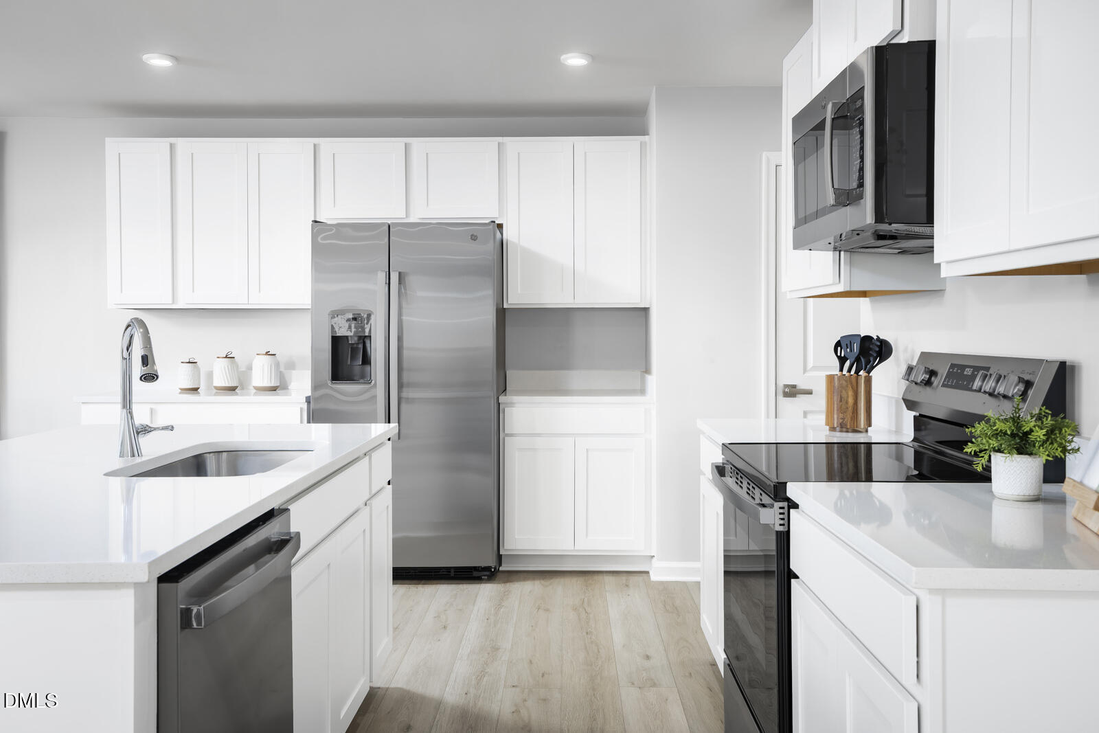 1007 Merlin Street Durham, NC 27704 - Photo 5 of 18 a kitchen with stainless steel appliances granite countertop a sink stove and refrigerator