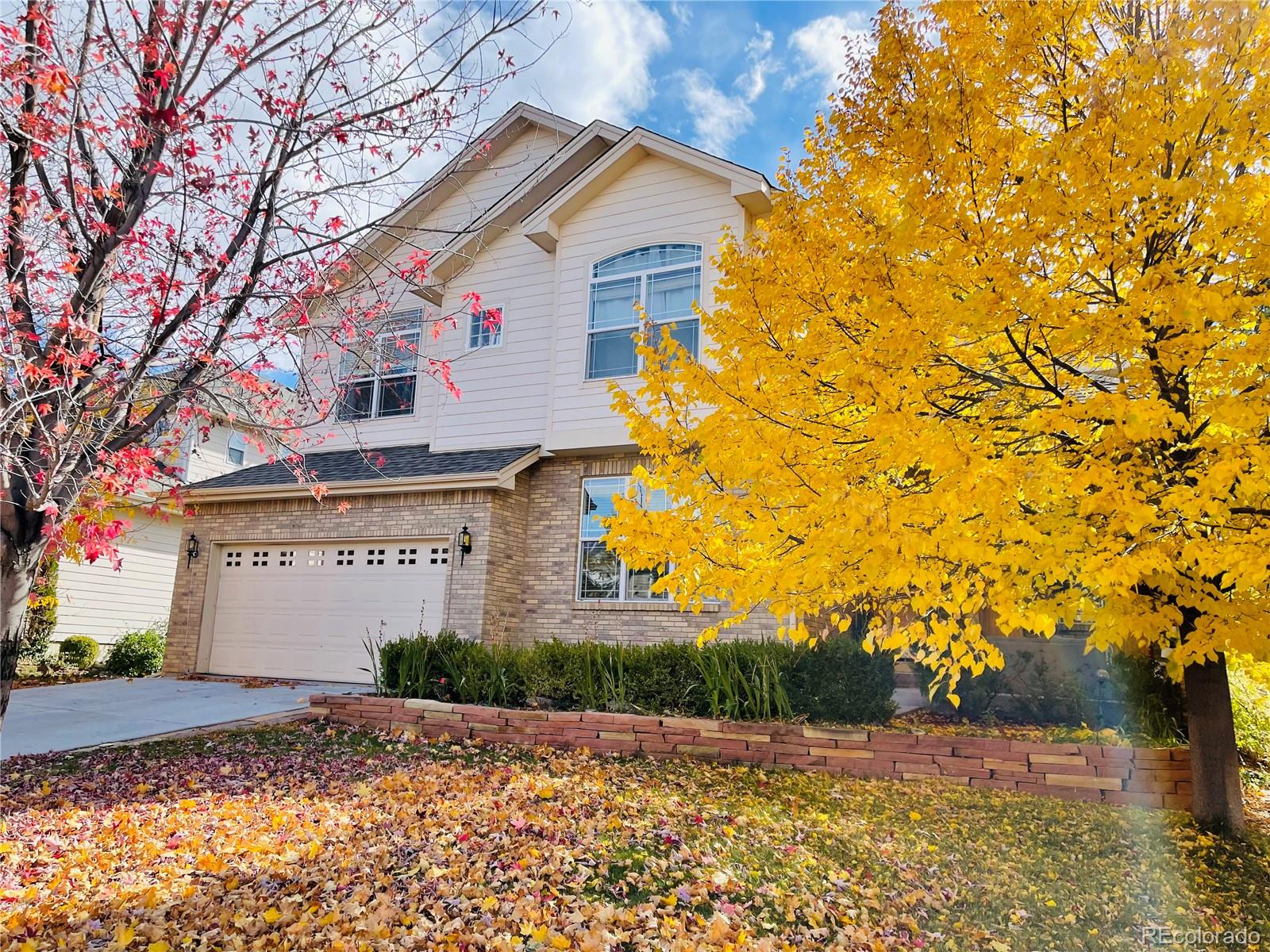 16866 East Peakview Avenue Aurora, CO 80016 - Photo 1 of 27 a front view of a house with a yard and garage