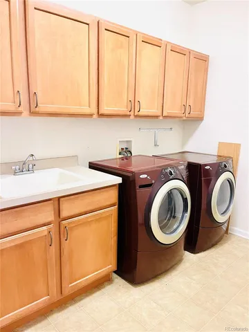 a utility room with sink dryer and washer