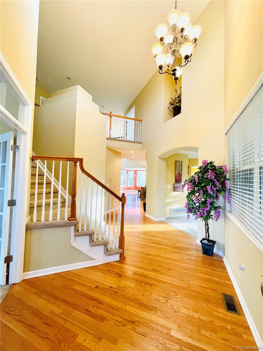 16866 East Peakview Avenue Aurora, CO 80016 - Photo 4 of 27 a view of an entryway with wooden floor