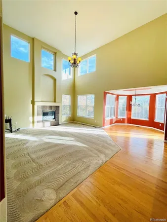 a view of an empty room with a kitchen