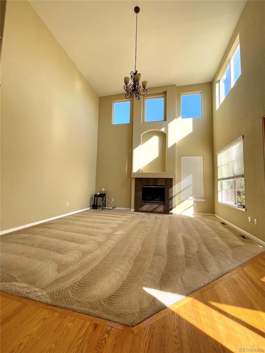 16866 East Peakview Avenue Aurora, CO 80016 - Photo 7 of 27 a bedroom with a bed and a fireplace