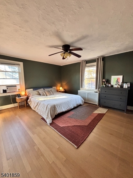 61 Luddington Road West Orange, NJ 07052 - Photo 12 of 25 a bedroom with a large bed and a chandelier