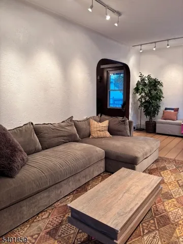 a living room with furniture and flowers