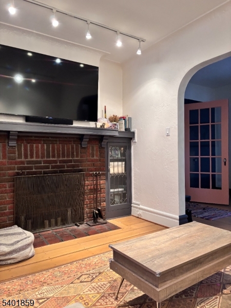 61 Luddington Road West Orange, NJ 07052 - Photo 7 of 25 a living room with a flat screen tv and a fireplace