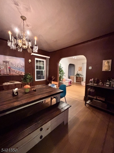 61 Luddington Road West Orange, NJ 07052 - Photo 9 of 25 a living room with furniture a chandelier and a fireplace
