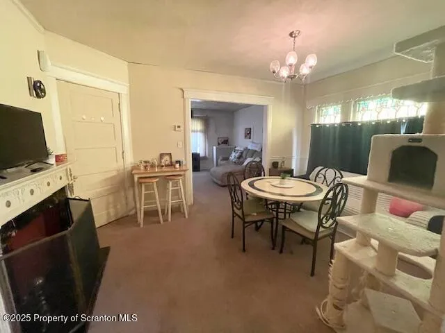 a view of a dining room with furniture and a chandelier