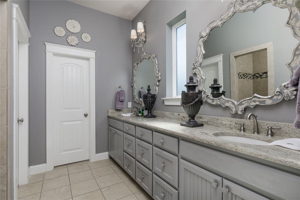 2500 Addison Street McKinney, TX 75071 - Photo 15 of 33 Primary bathroom features dual sinks and a large walk in shower.