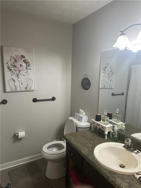 10 Dial Road Monroe, GA 30655 - Photo 6 of 13 a bathroom with a granite countertop toilet sink and mirror