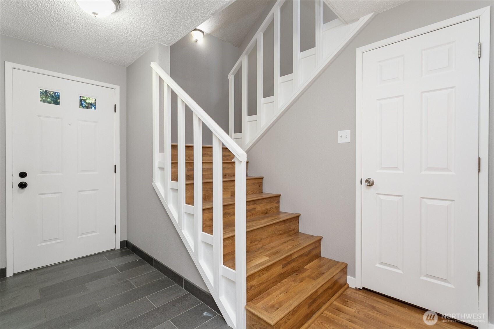1802 Maple Lane, Unit A5 Kent, WA 98030 - Photo 10 of 27 a view of staircase with wooden floor and white walls